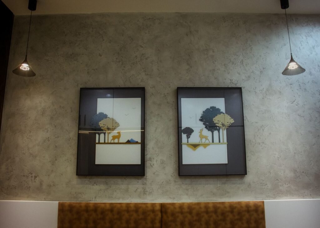 Chic modern interior featuring framed nature artwork and pendant lighting.
